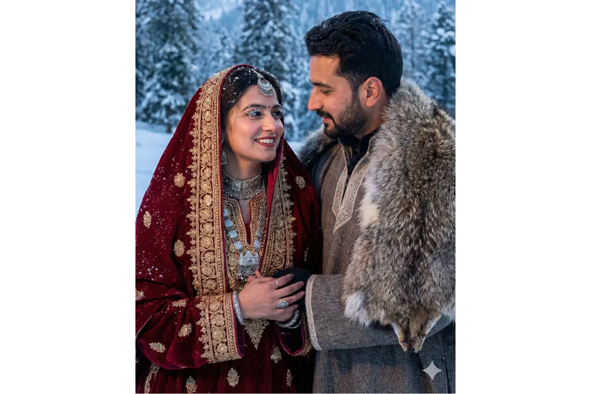 snow wedding in Gulmarg, medium close shot stunning Kashmiri-Indian couple in pheran-inspired bridal outfits with heavy embroidery, bride with fresh snowflakes on eyelashes, groom in fur-trimmed shawl, pine trees and mountains behind