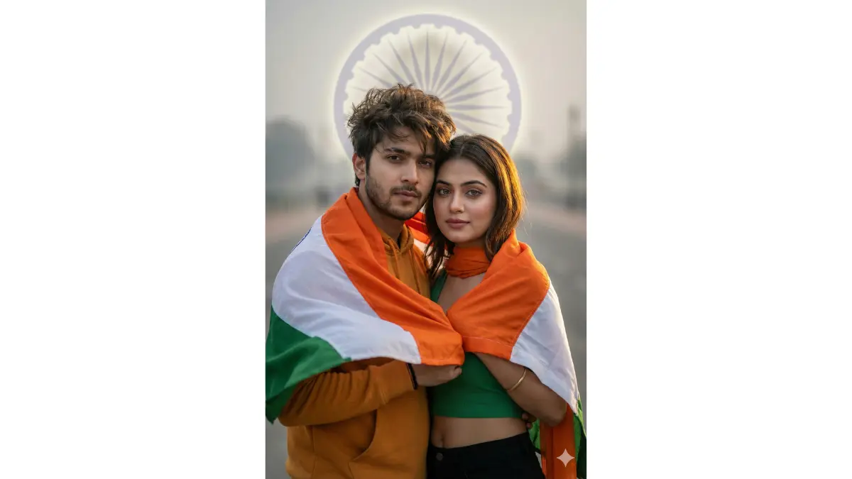 Ultra-cinematic patriotic portrait, tight medium close-up (chest-up, faces large and dominant in frame) of a young Gen-Z Indian couple in their early 20s. They stand very close together with arms subtly linked, looking confident and united. A flowing Indian tricolor flag drapes naturally around their shoulders, fabric caught mid-motion.